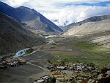 01 View Back Towards Nyalam From Milarepa Cave Just 10 km from Nyalam is a cave where the famous Tibetan Yogi, Milarepa, meditated for many years in the 11C. This is the view back towards Nyalam in 1998, with the Zhonggang village below.